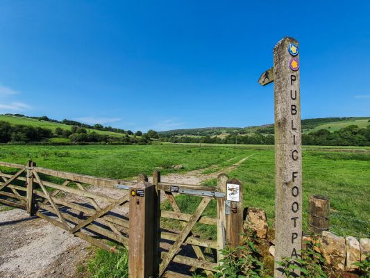 Signpost and gate into field